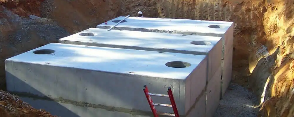 Septic tank installation site with a newly placed concrete tank in Boston, MA